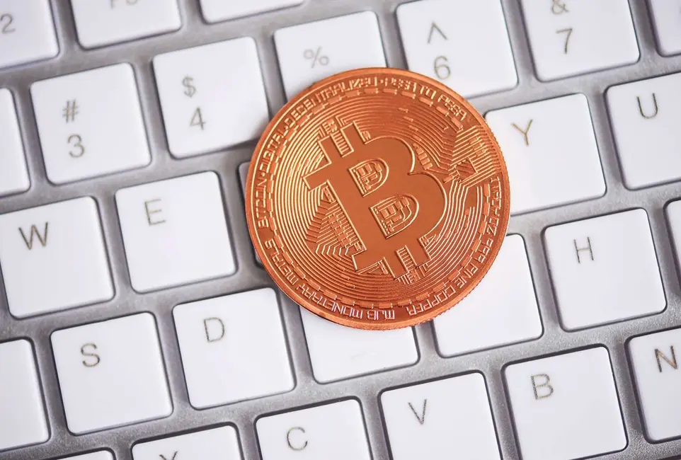تصویری از یک بیتکوین فیزیکی روی صفحهکلید