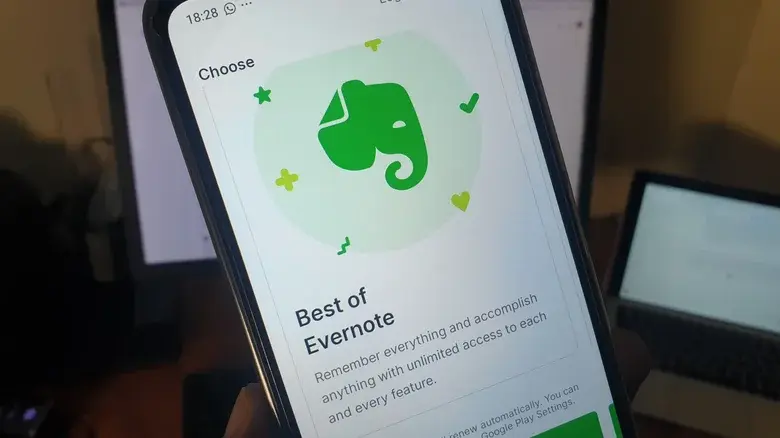 فردی که گوشی با اپلیکیشن Evernote باز را در دست دارد